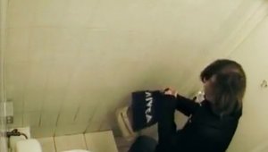Pissing in toilet together with amateur